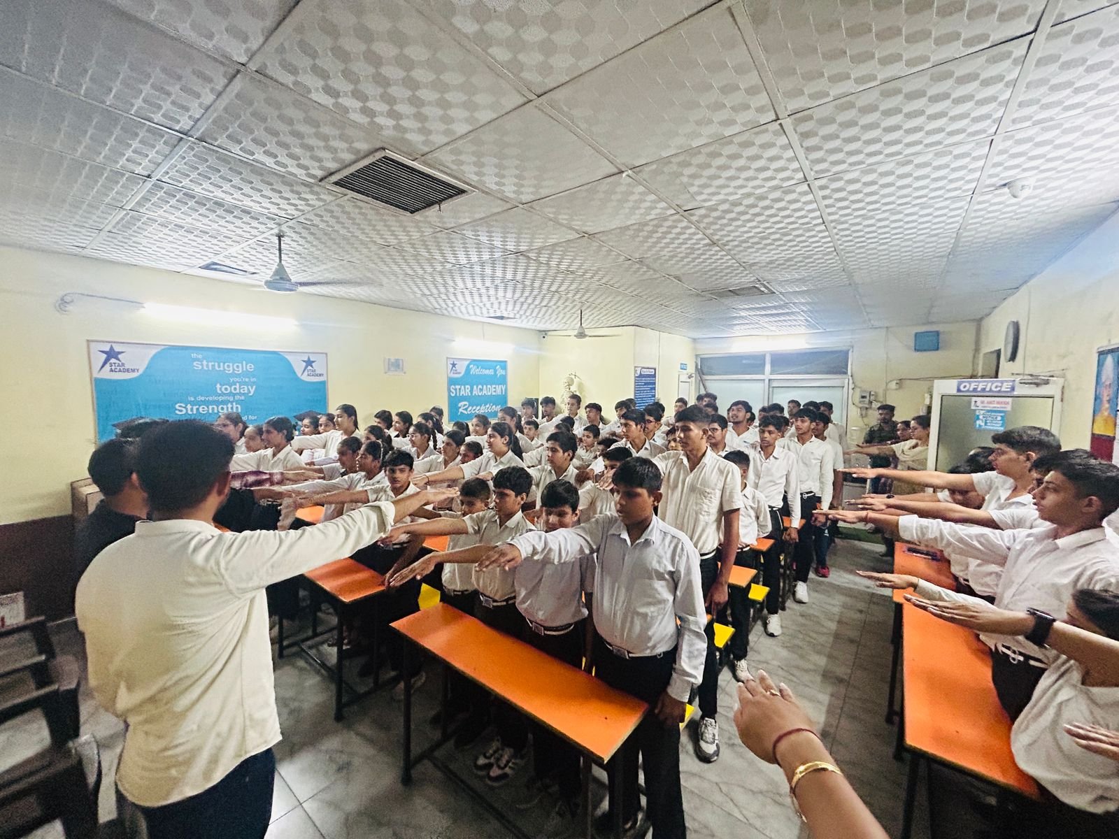 Students taking the pledge with determination and unity.